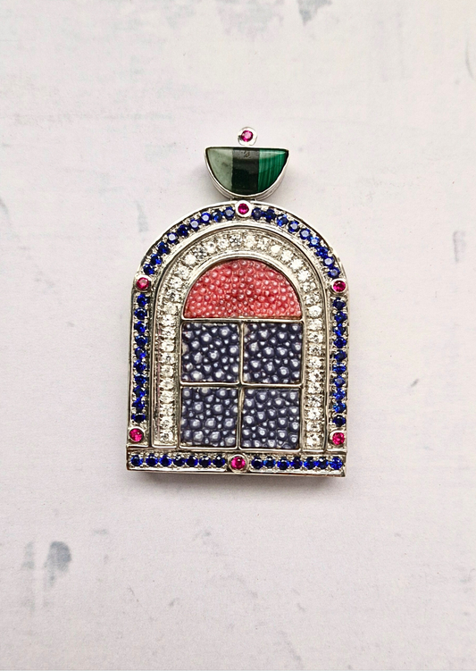 Jewelry piece with multicolored gemstones on a light gray background