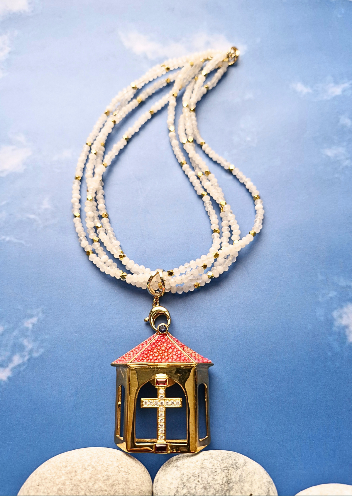 Necklace with a decorative pendant on a blue textured background