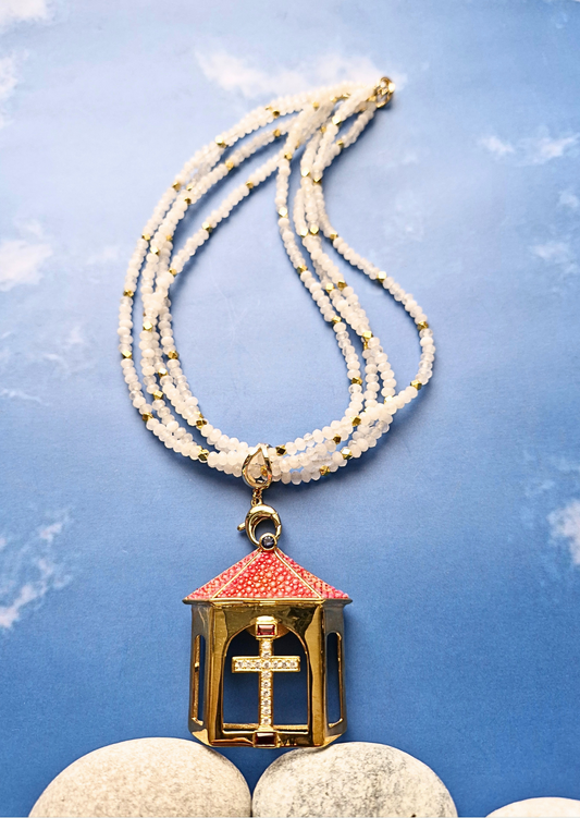 Necklace with a decorative pendant on a blue textured background