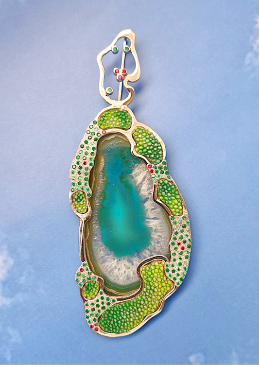 Decorative object with green and gold detailing on a blue background